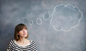 woman with thought bubble on chalk board