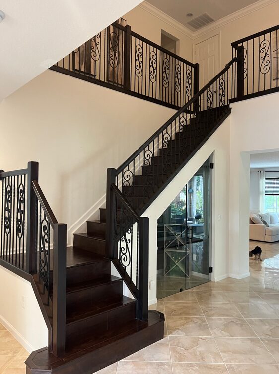 Staircase with newly stained banister, showcasing a DIY transformation for a stunning home upgrade