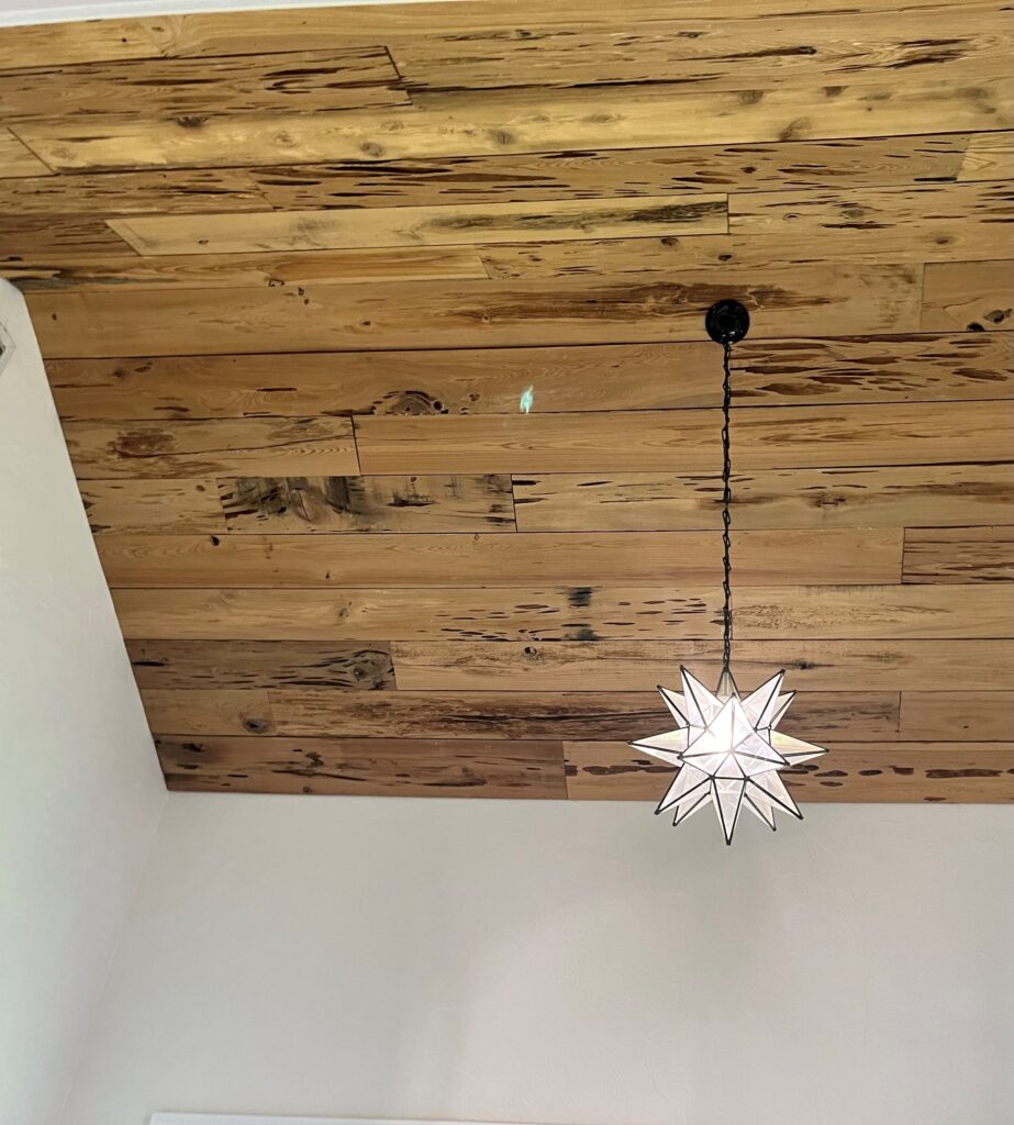 Image of pecky cypress ceiling before lime washing: "Unfinished pecky cypress ceiling ready for lime washing."